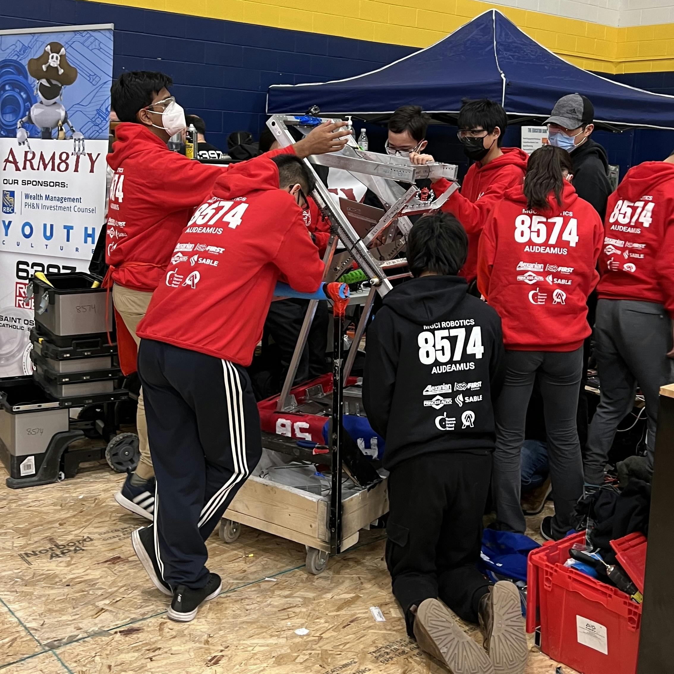 Team working on robot in pit